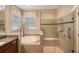 Bathroom with walk-in shower and soaking tub at 2564 Grand Cypress Blvd, Palm Harbor, FL 34684