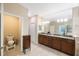 Bathroom with double vanity and granite countertop at 2564 Grand Cypress Blvd, Palm Harbor, FL 34684