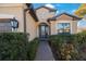 Front entry with a decorative door and walkway at 2564 Grand Cypress Blvd, Palm Harbor, FL 34684