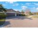 Two-car garage with brick paver driveway at 2564 Grand Cypress Blvd, Palm Harbor, FL 34684