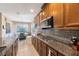 Spacious kitchen with granite countertops, wood cabinets, and stainless steel appliances at 2564 Grand Cypress Blvd, Palm Harbor, FL 34684