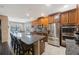 Modern kitchen with granite countertops, stainless steel appliances, and breakfast bar at 2564 Grand Cypress Blvd, Palm Harbor, FL 34684