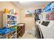 Laundry room with shelving, a sink and a washer and dryer at 2564 Grand Cypress Blvd, Palm Harbor, FL 34684