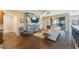 Open living room with a modern fireplace, comfortable seating, and hardwood floors at 2564 Grand Cypress Blvd, Palm Harbor, FL 34684