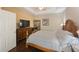 Large main bedroom with wood furniture and a TV at 2564 Grand Cypress Blvd, Palm Harbor, FL 34684