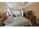 Main bedroom with king-size bed and access to the sitting area at 2564 Grand Cypress Blvd, Palm Harbor, FL 34684
