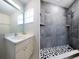 Updated bathroom with a large walk-in shower and pebble floor at 3123 W Rio Vista Ave, Tampa, FL 33614