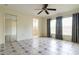 Spacious bedroom with tile flooring, ceiling fan, and mirrored closet doors at 3123 W Rio Vista Ave, Tampa, FL 33614