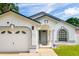 White house with gray accents, two-car garage, and a nicely landscaped front yard at 3123 W Rio Vista Ave, Tampa, FL 33614