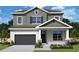 Two-story house with gray siding, dark garage door, and landscaping at 3218 21St N St, St Petersburg, FL 33713