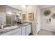 Elegant bathroom with double vanity, granite countertop, and walk-in shower at 32443 Osprey Peak Way, San Antonio, FL 33576
