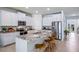Island kitchen with granite countertops and white cabinets at 32443 Osprey Peak Way, San Antonio, FL 33576