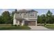 Two-story house with brown garage door and gray siding at 35233 Gravelly Dr, Zephyrhills, FL 33541