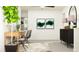 Modern home office with a wooden desk and two comfortable chairs at 35233 Gravelly Dr, Zephyrhills, FL 33541