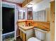 Bathroom with wood cabinets, copper sink, and a view into another room at 4231 Tamargo Dr # 3, New Port Richey, FL 34652