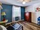 Bedroom with blue walls, wood floors, and a dresser at 4231 Tamargo Dr # 3, New Port Richey, FL 34652