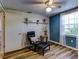 Bedroom with blue walls, wood floors, and a comfortable armchair at 4231 Tamargo Dr # 3, New Port Richey, FL 34652