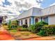 White building with blue accents, metal roof, and landscaping at 4231 Tamargo Dr # 3, New Port Richey, FL 34652