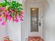 White front door with louvered glass and pink flower at 4231 Tamargo Dr # 3, New Port Richey, FL 34652