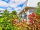 Landscaped garden with lush greenery and terracotta pots at 4231 Tamargo Dr # 3, New Port Richey, FL 34652