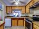 Kitchen with wood cabinets, stainless steel appliances, and tile counters at 4231 Tamargo Dr # 3, New Port Richey, FL 34652