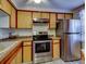 Bright kitchen features stainless steel appliances and wood cabinets at 4231 Tamargo Dr # 3, New Port Richey, FL 34652