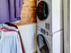 Stackable washer and dryer in a laundry closet with wood-paneled walls at 4231 Tamargo Dr # 3, New Port Richey, FL 34652