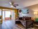 Relaxing living room with L-shaped couch and wood floors at 4231 Tamargo Dr # 3, New Port Richey, FL 34652