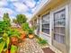Private patio with stone pavers and colorful potted plants at 4231 Tamargo Dr # 3, New Port Richey, FL 34652