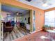 Bright sunroom with terracotta tile floors and a ceiling fan at 4231 Tamargo Dr # 3, New Port Richey, FL 34652