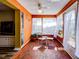 Bright sunroom with tiled floor, glass table, and white chairs, offering a relaxing space at 4231 Tamargo Dr # 3, New Port Richey, FL 34652