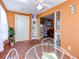 Sunroom features a glass table, built-in shelving, and views into the living room at 4231 Tamargo Dr # 3, New Port Richey, FL 34652