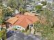 An aerial view shows the unique metal roof and mature landscaping of this quaint home at 4829 W San Miguel St, Tampa, FL 33629