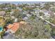 A scenic aerial view showcasing a charming home, lush landscaping, and canal access in a desirable neighborhood at 4829 W San Miguel St, Tampa, FL 33629