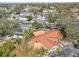 This aerial view showcases the home's unique metal roof, landscaping, and a canal nearby at 4829 W San Miguel St, Tampa, FL 33629