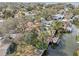 Aerial view of the house near a canal with boat dock, mature trees, and beautiful surrounding houses at 4829 W San Miguel St, Tampa, FL 33629