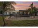Inviting backyard with a fenced pool, covered patio with lights, and tropical landscaping at 4829 W San Miguel St, Tampa, FL 33629