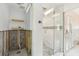 Bathroom interior showcasing modern shower with glass door, shelves, and updated plumbing at 4829 W San Miguel St, Tampa, FL 33629
