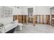 Bathroom with a clawfoot tub and marble floors undergoing remodeling work at 4829 W San Miguel St, Tampa, FL 33629