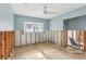 Bright bedroom featuring a ceiling fan, window, and light blue walls, ready for customization at 4829 W San Miguel St, Tampa, FL 33629