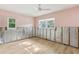 Inviting bedroom featuring a ceiling fan, two windows, and light pink walls, offering a cozy atmosphere at 4829 W San Miguel St, Tampa, FL 33629
