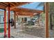 Outdoor workspace featuring a covered carport, exercise equipment, utility table, and space for parking a car at 4829 W San Miguel St, Tampa, FL 33629
