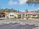 Inviting home exterior showcasing a metal roof and landscaping, set on a spacious lot at 4829 W San Miguel St, Tampa, FL 33629