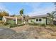 Charming single-story home with a quaint front yard and a distinctive metal roof at 4829 W San Miguel St, Tampa, FL 33629