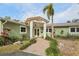 Charming single-story home with lush landscaping, front yard, and a brick walkway at 4829 W San Miguel St, Tampa, FL 33629