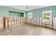 Spacious room featuring light blue walls, wood flooring, and abundant natural light from large windows at 4829 W San Miguel St, Tampa, FL 33629
