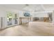 Spacious living room with light wood floors and direct access to the backyard at 4829 W San Miguel St, Tampa, FL 33629