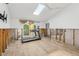 Bright living space featuring tile floors, a skylight, and a ceiling fan, perfect for workouts at 4829 W San Miguel St, Tampa, FL 33629