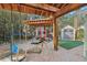 Covered outdoor patio with a backyard shed and workout equipment at 4829 W San Miguel St, Tampa, FL 33629