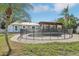 Well-maintained backyard pool featuring a surrounding safety fence, patio and lush landscaping at 4829 W San Miguel St, Tampa, FL 33629